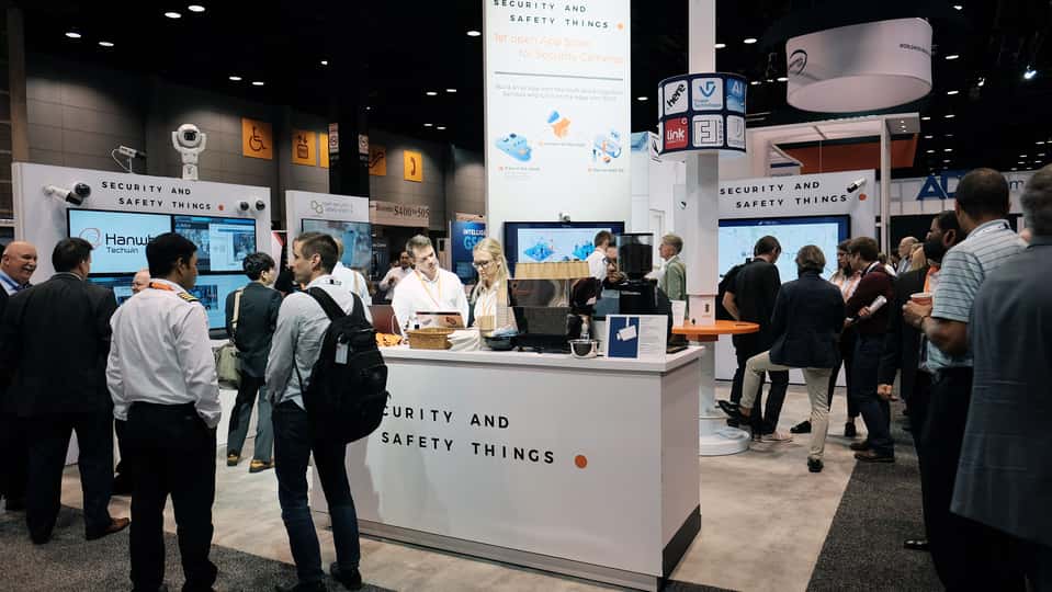 Busy trade fair booth with interactive product demos