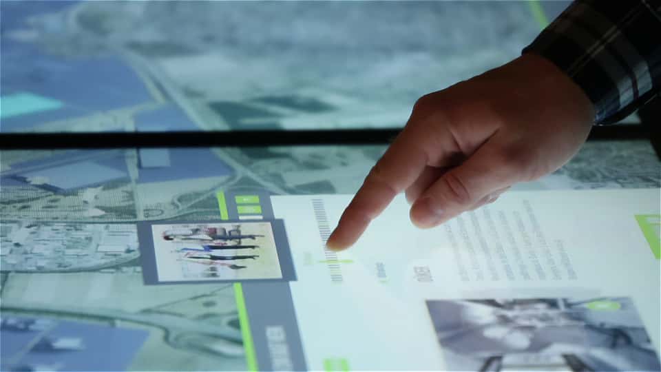 Close-up of a user navigating textual and visual content on the BASF interactive media table.