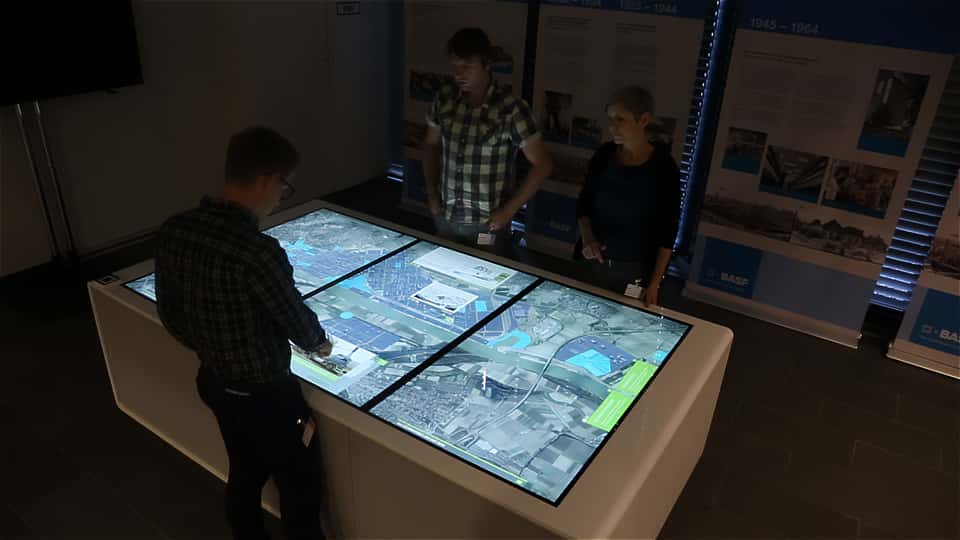 Visitors gathered around the BASF media table during a guided session in the visitor center.