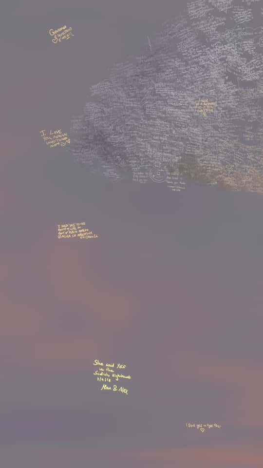 Still of the VASHI Love Wall installation showing a colorful cloud of animated particles forming hand-drawn shapes and messages.